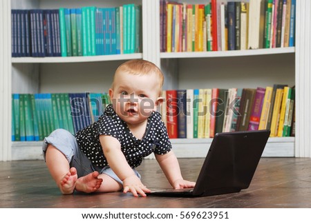 Cute white Eight months old toddler baby playing with tablet personal computer on the floor