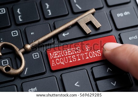 Closed up finger on keyboard with word MERGERS & ACQUISITIONS Royalty-Free Stock Photo #569629285