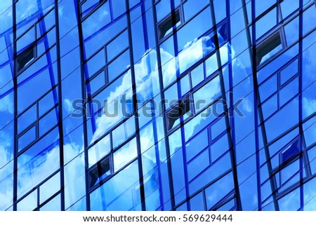 Transparent wall reflecting bright blue sky with clouds. Modern architecture. Reworked photo of hi-tech office building fragment. Abstract glass background with hint of eco-friendly technologies