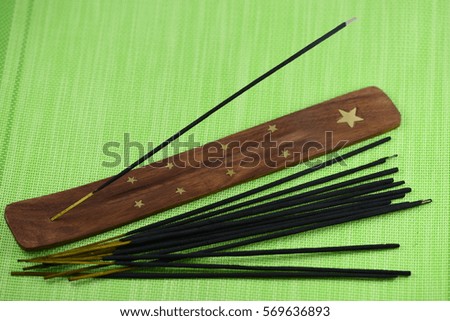 incense stick or joss stick on green background
