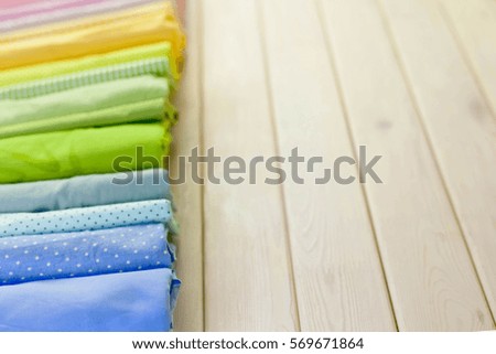 Cotton colored fabric. Background of white wood.