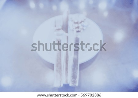 Picture blurred  for background abstract and can be illustration to article of white plate with silver fork knife and spoon