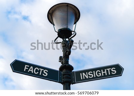 Street lighting pole with two opposite directional arrows over blue cloudy background. Facts versus Insights concept.