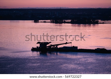 Beautiful metal ship silhouette on river at summer evening