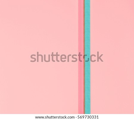 Blue and pink zipper on a pink background. Flat lay conception in minimal style.