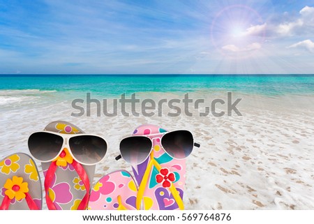 beach shoes with sunglasses on tropical sea and sky background