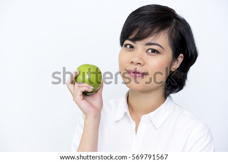 Portrait of positive Asian woman holding apple