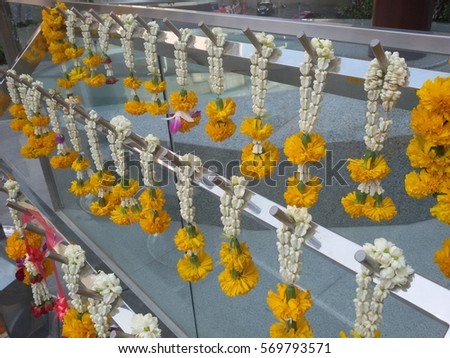 Thai style traditional wreath of flowers for paying respect to Buddhist monk statue