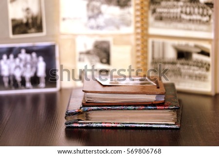 Old Albums with Black and White Nostalgic Blurry Photos in Background