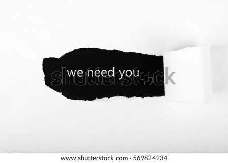 Paper torn and motivational text we need you