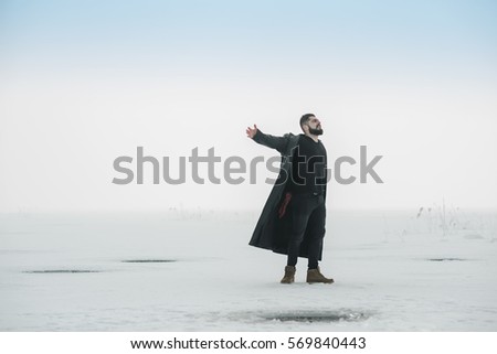 the concept of freedom and life, young man joyously throws her hands on a frozen lake