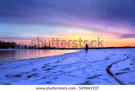 Lonely human figure on a snowy beach in Birds Hill Park, Manitoba, Canada. 