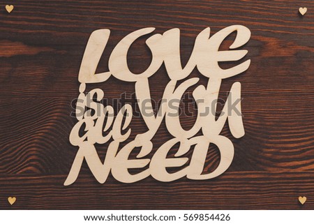 Simple writing about love on wooden background