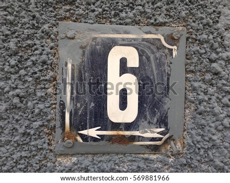 Vintage grunge square metal rusty plate of number of street address with number 6 closeup