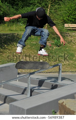 Skateboarder doing a trick at the local skate park