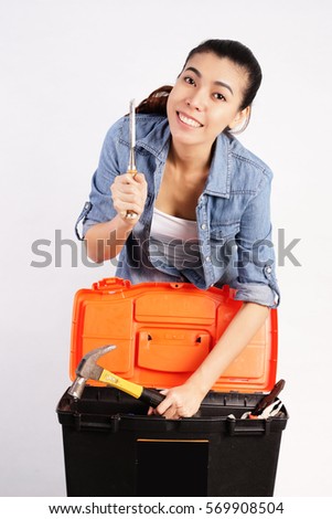 Smiling Woman Searching a tools Box on White Background, Construction and Repair Concept