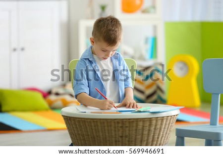 Little boy drawing picture at child psychologist's office