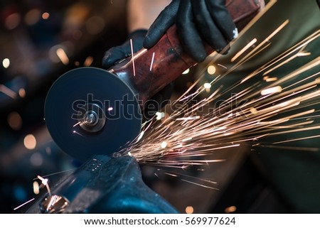 Metal Cutting Tool in Action Closeup Photo. Residential Small Metal Works.