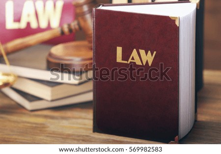 Law book on wooden background