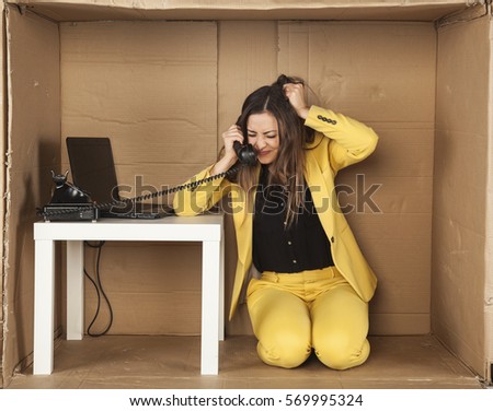 angry business woman pulls her hair during a telephone conversation