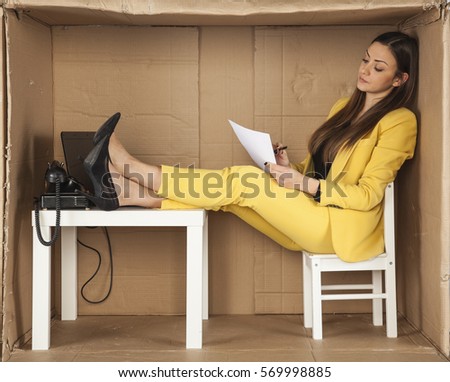 business woman reads documents and keeps his feet on the desk