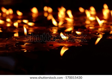 Candle light float on the water.