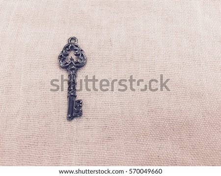 vintage key on pink fabric texture background