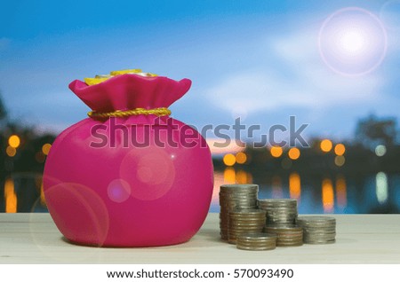 Piggy bank or money box with money coins in saving money concept.
