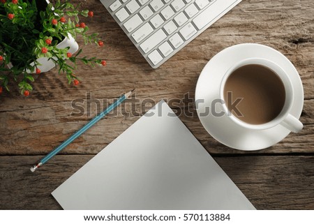 Table top  view with paper pencil, vases, coffee cup on old rustic wooden background.