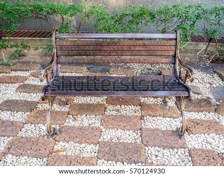 A wooden bench offers a place to sit in a park.