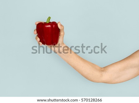 Hand Holding Red Bell Pepper