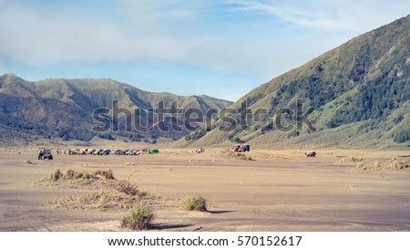 Color processing of image tourist car park at sand desert with mountain valley as background - Bromo Indonesia - Vintage filter