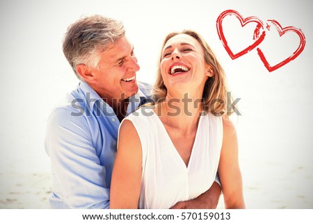 Happy couple laughing together against print
