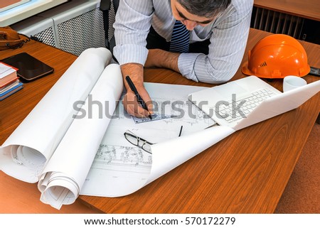 Designer at work. Checking the project. Correction of the drawing.