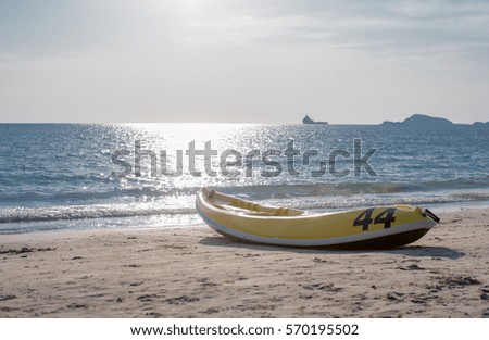 Yellow canoe on beach with 