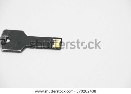Key types thumb drive on white background