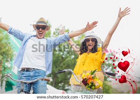 Valentines heart design against portrait of excited couple with bicycles 3d