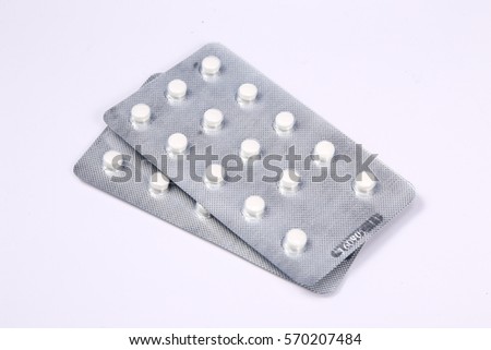 white pills in white background