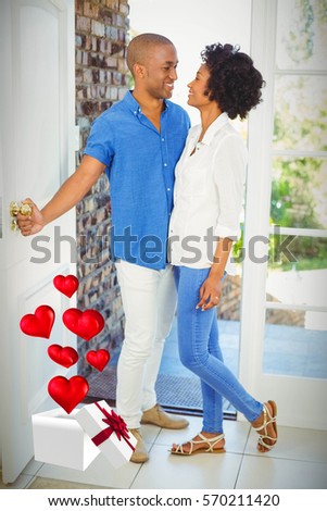 Hearts flying from box against couple about to open door 3d