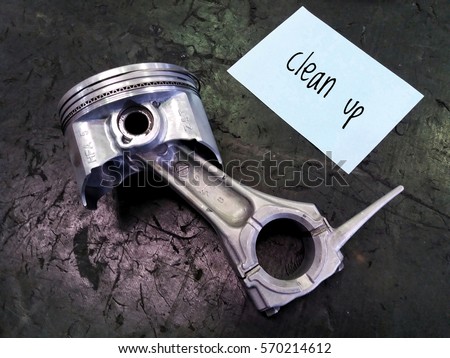 conceptual image of piston assembly and word - Clean up with black background/selective focus/low light.