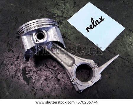 conceptual image of piston assembly and word - Relax with black background/selective focus/low light.