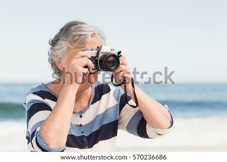 Senior woman taking picture on a sunny day
