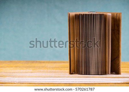 Open book on wooden table. Back to school. Copy space. Top view.