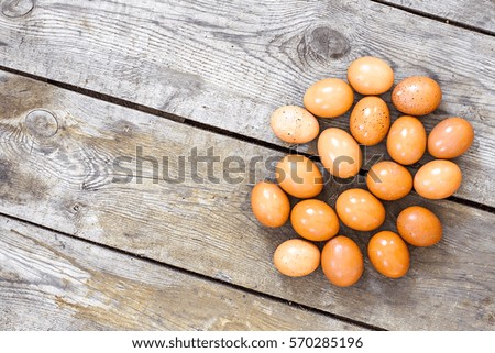 Raw eggs on wooden background.