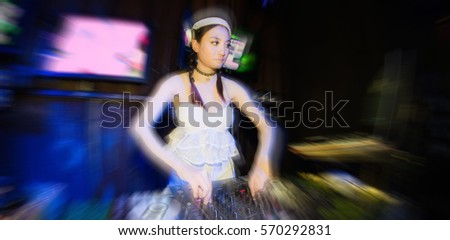 Blur Lady Dj in club party,slow sync flash technique is feeling movement. 