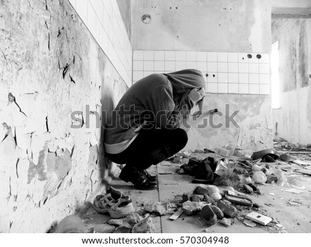 Sitting women in depression, young sadness women crying in old dirty abandoned house Royalty-Free Stock Photo #570304948