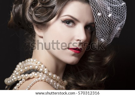 Beautiful vintage hairstyle with a white hat. Studio photography