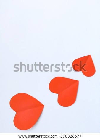 Cutting paper red hearts, Hearts from cutting paper Isolated on White Background. Cards for Valentine's Day There is space for text "Happy Valentine's Day"