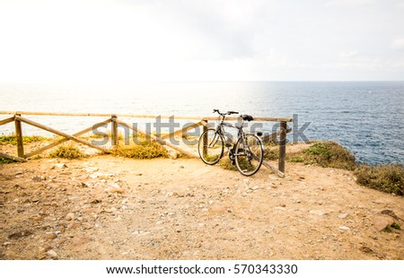 Blurred image. Bicycle parked on the beach with sunny day in tone vintage style.