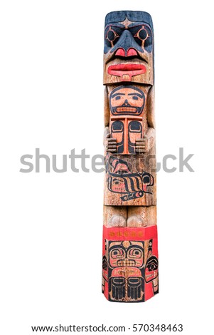 Totem pole with various tribal faces isolated on white background Royalty-Free Stock Photo #570348463